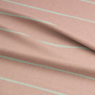 Close-up of Loire blush striped upholstery fabric, showcasing its durable texture and delicate stripe design.