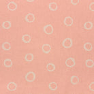 Blush spotted polka dot upholstery fabric with a soft pastel hue, perfect for adding warmth to furniture pieces.