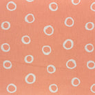Peach spotted polka dot upholstery fabric with a warm, inviting feel, ideal for classic and modern interiors.