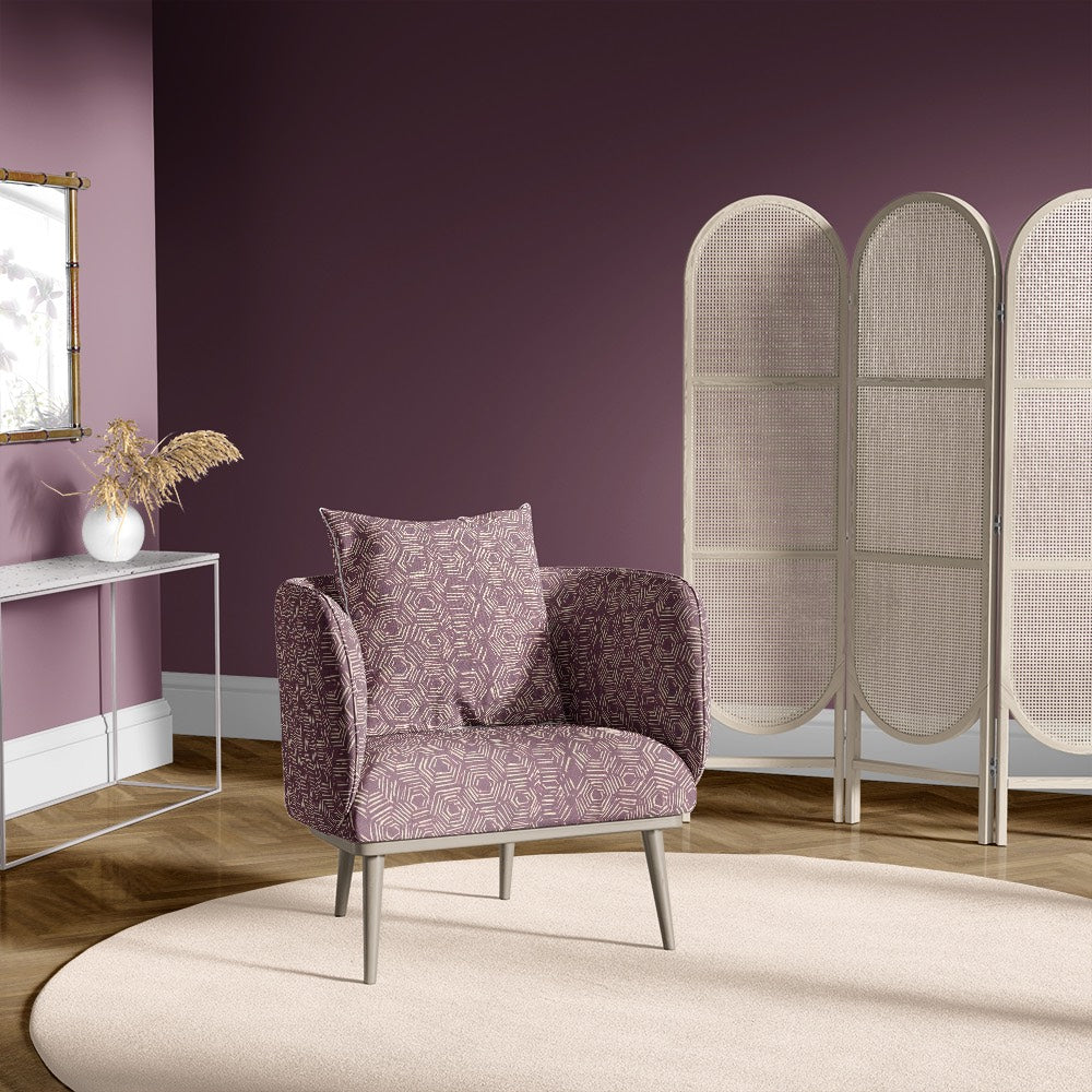 Accent chair in Newton purple geometric upholstery fabric with hexagon pattern in a plum-coloured room