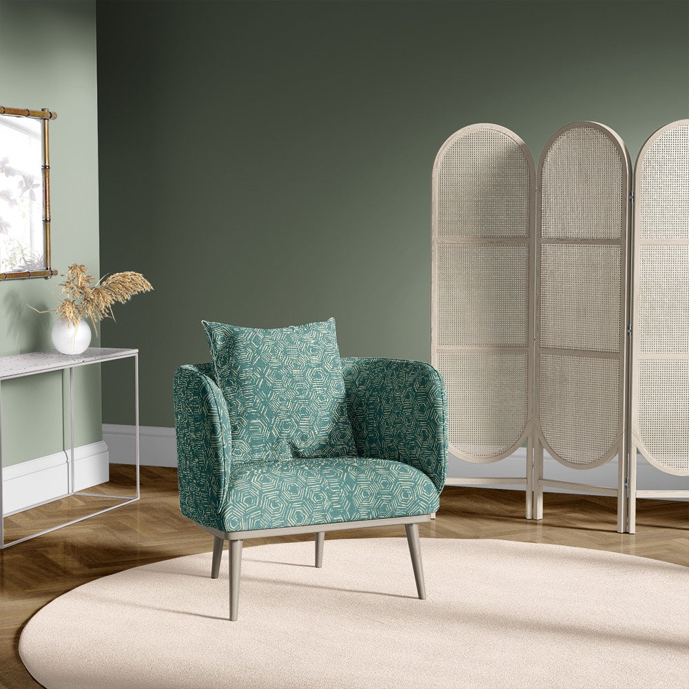 Teal armchair styled with Newton geometric upholstery fabric featuring hexagon pattern in a green-toned interior