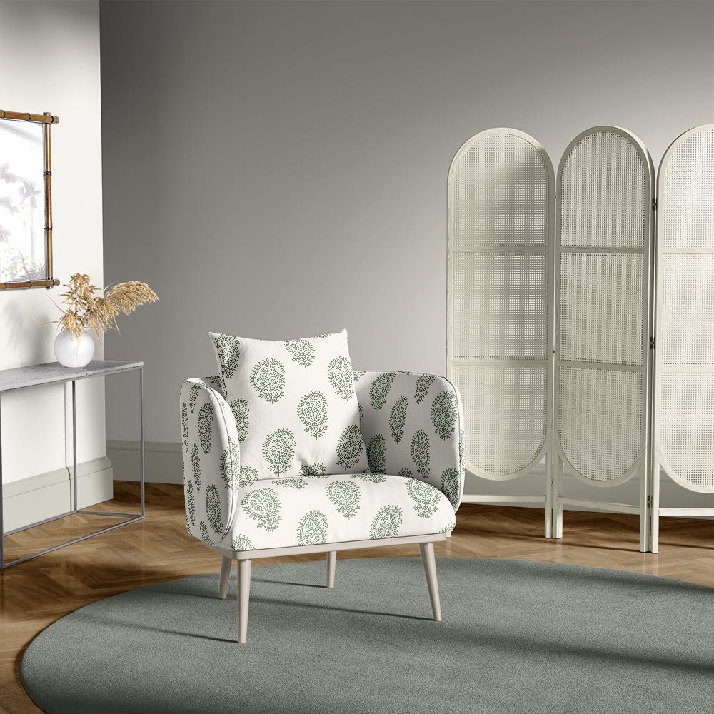 Armchair in paisley fennel green upholstery fabric, set in a grey interior with mid-century décor and light-toned furniture
