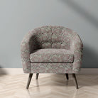 Penrose Floral Mist upholstery fabric on chair with muted pink and grey flower design