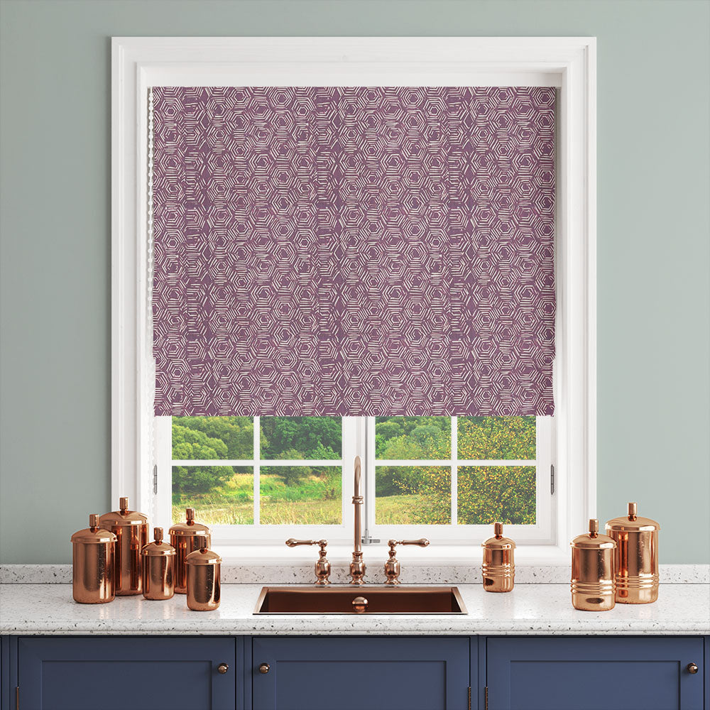 Purple geometric curtain fabric shown as a blind above a copper sink