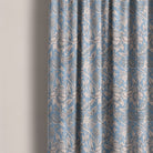 Floral curtain fabric in soft blue with intricate botanical detailing, perfect for classic and elegant interiors.
