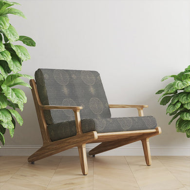 Solstace Golden Noir Upholstery Fabric on statement lounge chair