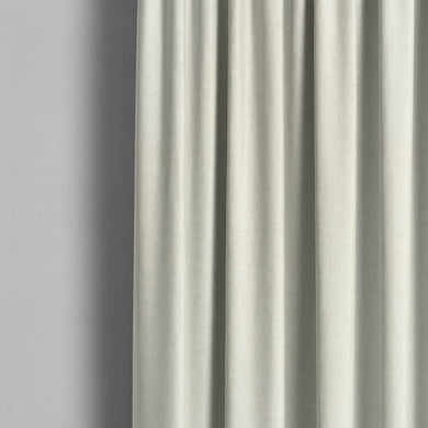 A room setting with the Stow Linen Curtain Fabric, adding a touch of elegance to the space