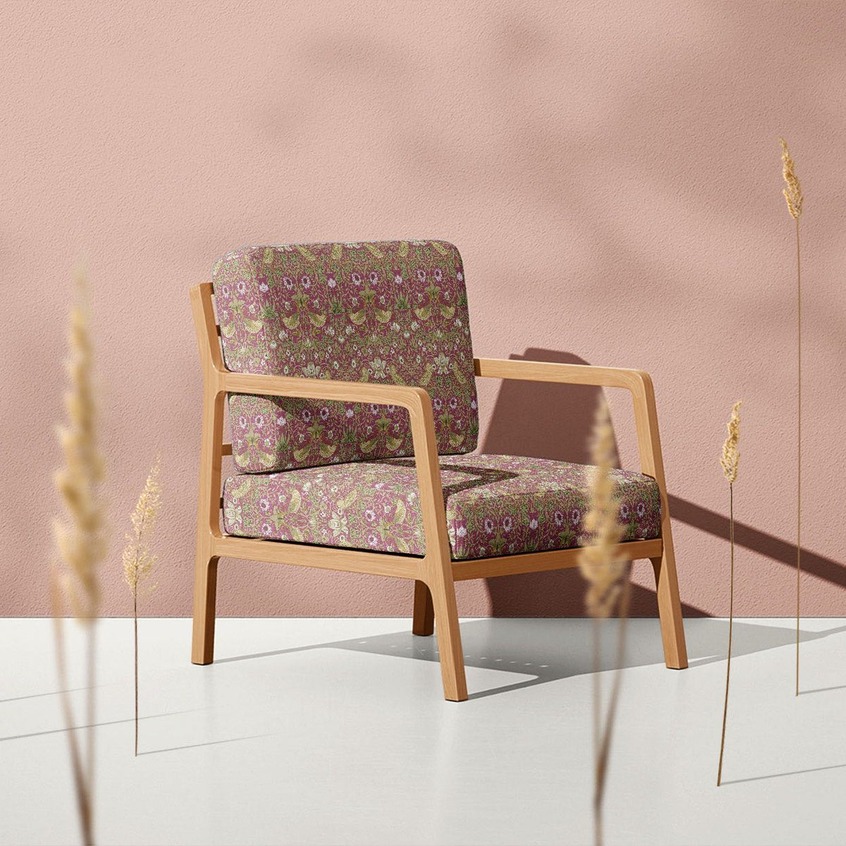 Magenta Strawberry Thief velvet upholstery fabric on a bold feature armchair
