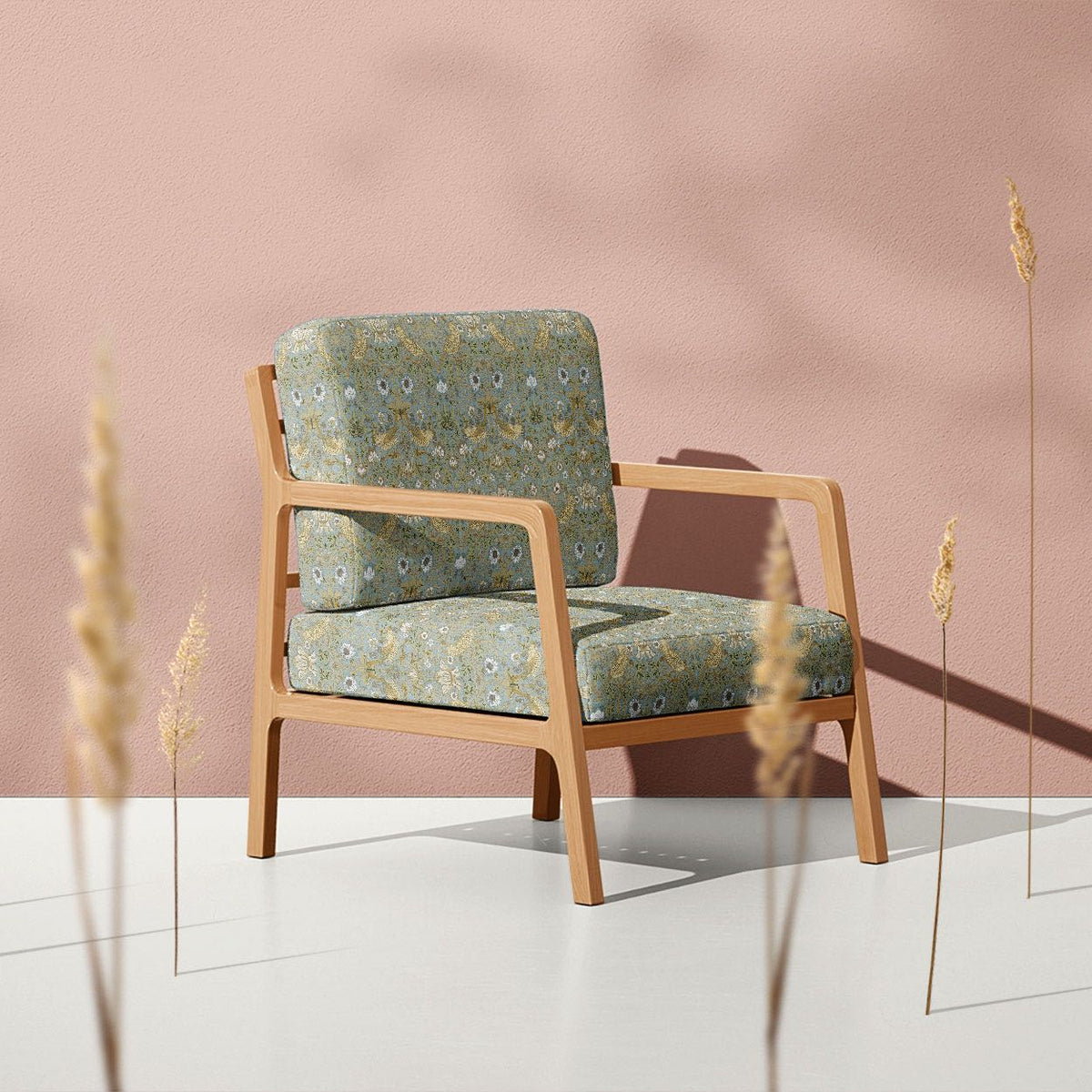 Nordic Strawberry Thief fire retardant velvet fabric on a soft neutral armchair