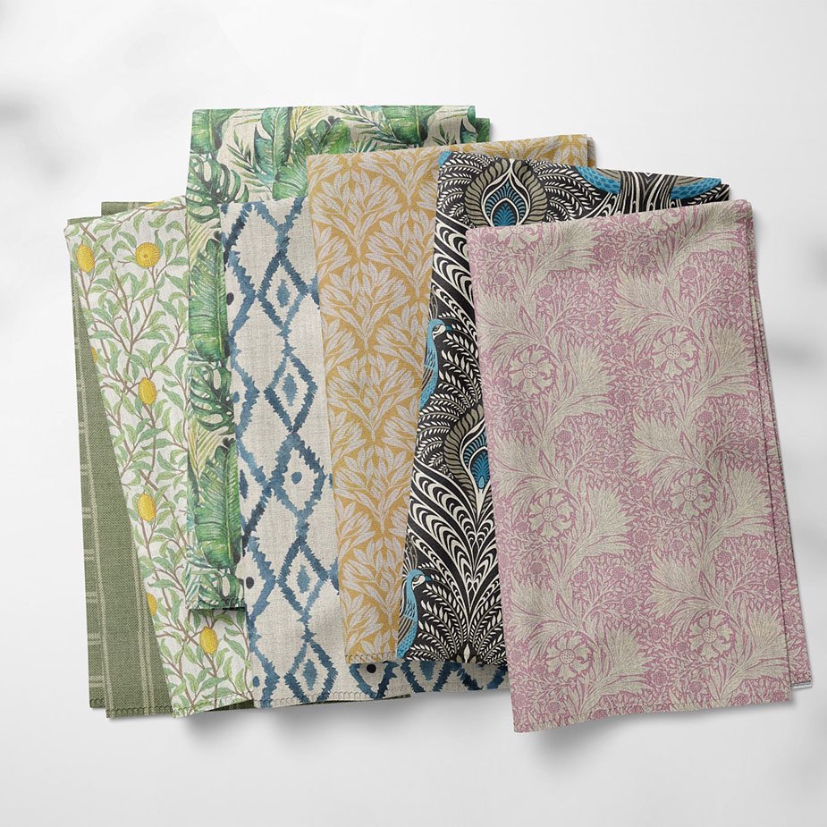 Selection of patterned curtain and upholstery fabrics in green, blue, ochre, black and pink by The Millshop Online