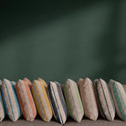 Tirso striped linen curtain fabric shown in 11 colourways with painterly stripe design