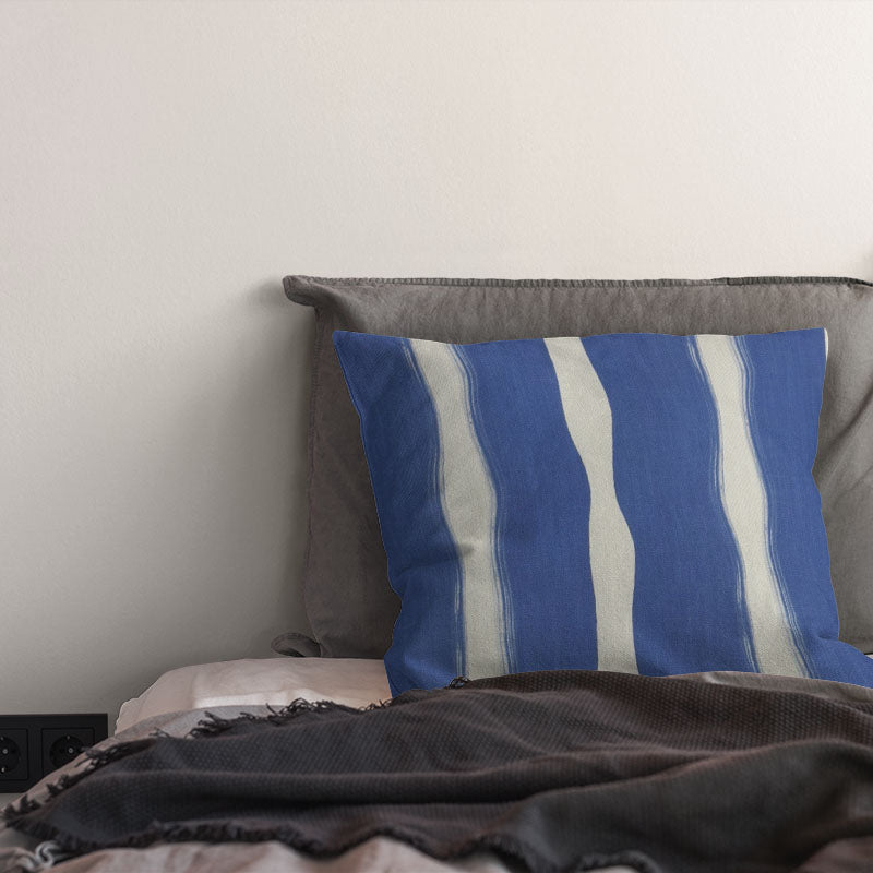 striped curtain fabric cushion in bold blue tones with flowing vertical stripe pattern on linen blend fabric