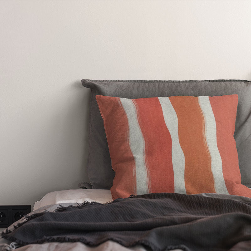 striped curtain fabric cushion in peach and coral tones with warm painterly stripe pattern on linen curtain fabric