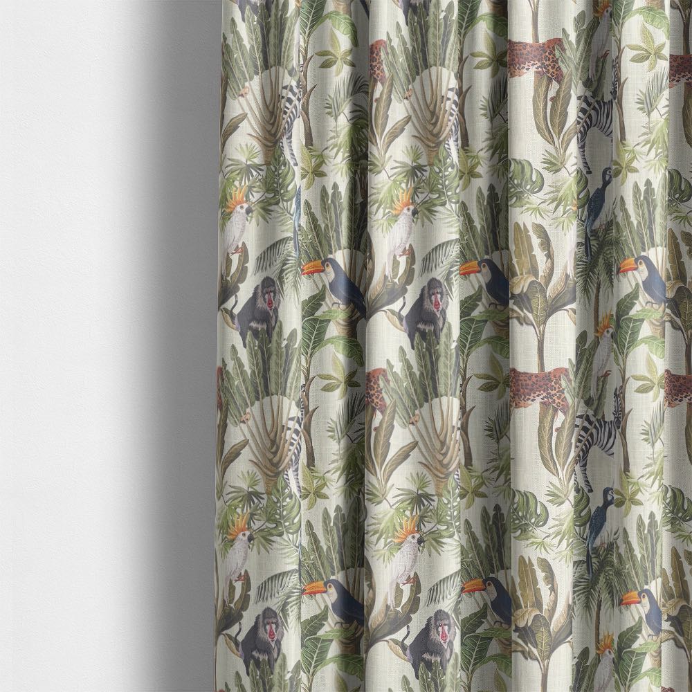 Valdivian ivory jungle curtain fabric shown hanging with zebra, toucan, and monkey design