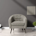 Armchair upholstered in Welford Charcoal fabric – highlighting bold geometric design in a modern setting.