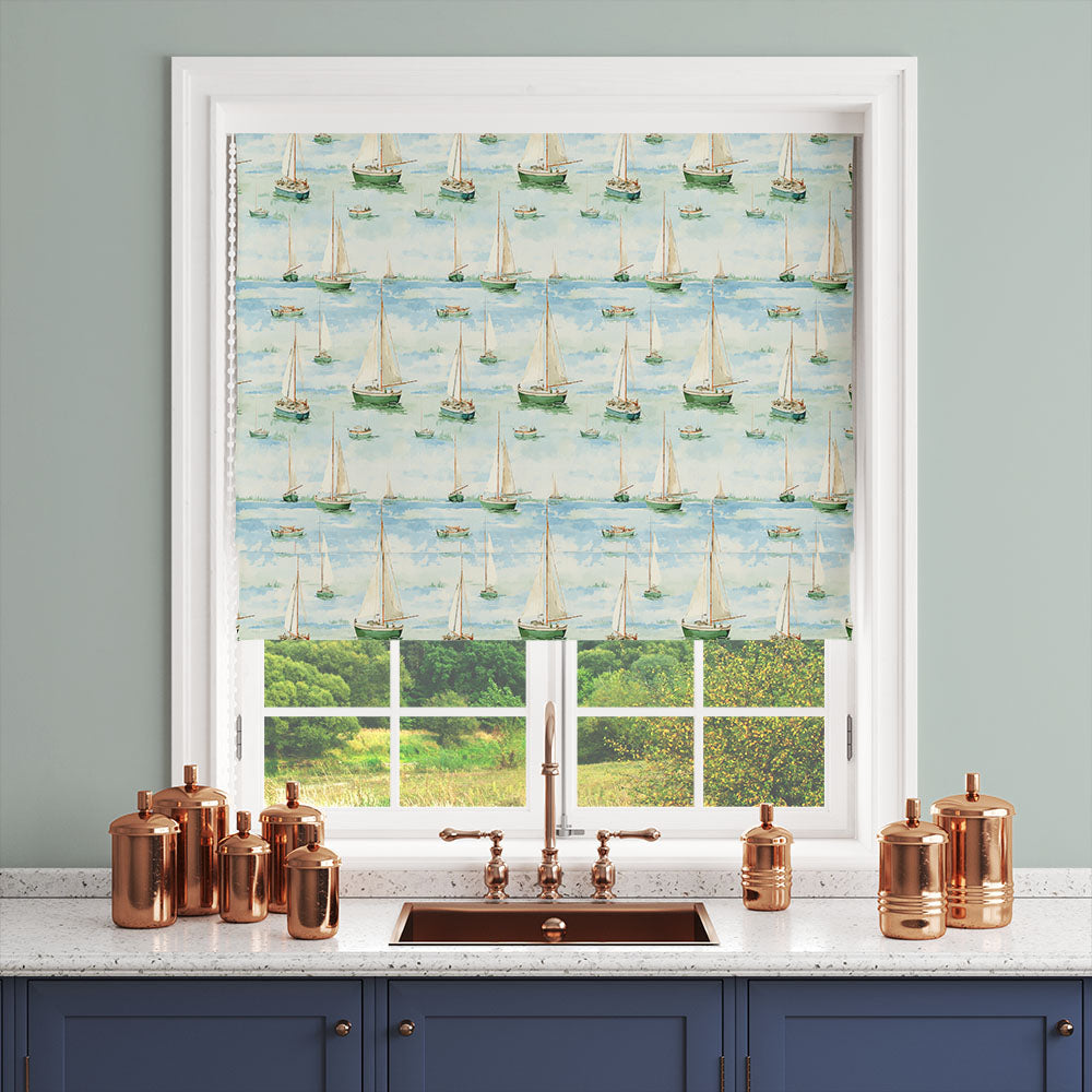 green seaside curtain fabric with sail boat pattern shown as roman blind in kitchen window interior