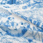 Elegant French-inspired fabric featuring pastoral scenes and delicate floral motifs in a classic blue and white color palette