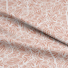 Close-up of Baran Linen Curtain Fabric in Terracotta with natural light filtering through