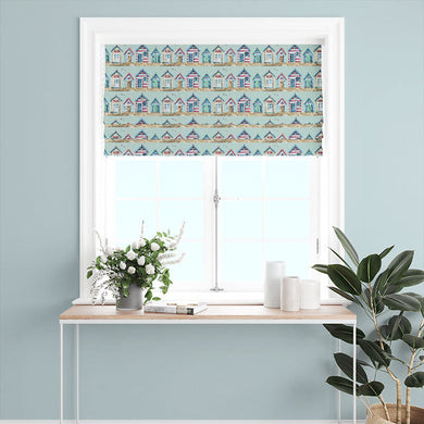 Beach Huts Cotton Curtain Fabric - Duck Egg hanging as a curtain in a beach-themed room