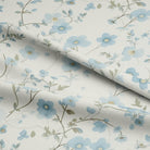 This luxurious cotton curtain fabric features a delicate floral pattern in a calming cornflower blue color, bringing a sense of tranquility to your home