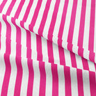 Close up of Candy Stripe Cotton Curtain Fabric in Cerise, showing the intricate woven pattern and texture