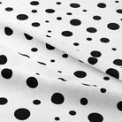 Black cotton fabric with a confetti print, perfect for creating stylish and modern curtains