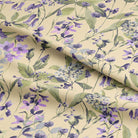 Close-up of Country Garden Butter fabric with floral motif on a linen blend