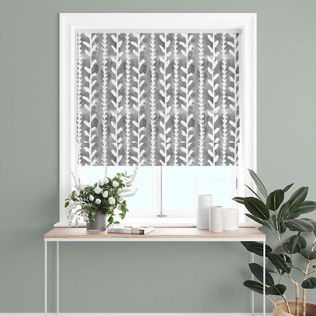 A pair of Delilah Cotton Curtain Fabric panels in Grey, creating a stylish and modern window treatment