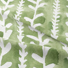 Close-up of the texture of Delilah Cotton Curtain Fabric in Pine, showcasing its soft and natural feel