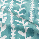 Delilah Cotton Curtain Fabric in Teal, a luxurious and durable material perfect for creating a cozy and stylish atmosphere in any room