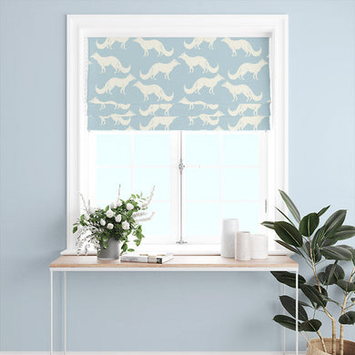 Curtain panels made of Foxy Linen Curtain Fabric - Sky Blue hanging in a window