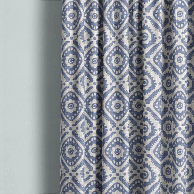 Ive Cotton Curtain Fabric - Blue hanging beautifully in a modern living room setting