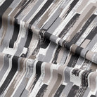Close-up of textured charcoal Modernism Cotton Curtain Fabric in natural light
