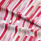 Room setting featuring Modernism Cotton Curtain Fabric in Strawberry, creating a modern and stylish ambiance