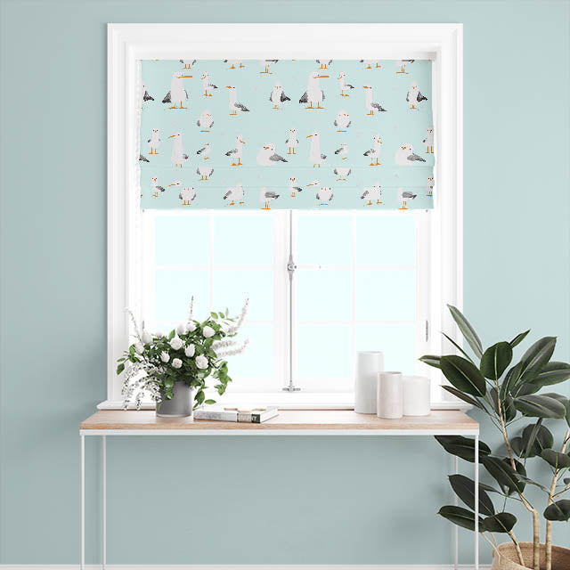 A full-length drape of the Duck Egg Blue Mouette Cotton Curtain Fabric, hanging gracefully in a room