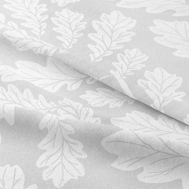 Close-up of Oak Leaf Cotton Curtain Fabric in Dove Grey, showing intricate leaf pattern