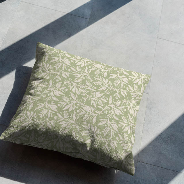 Oxford Leaf Green leaf pattern cushion styled on a neutral tiled floor