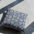 Indigo botanical cushion styled on floor in natural light