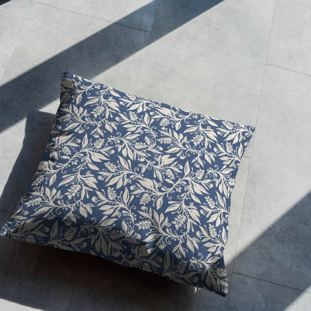 Indigo botanical cushion styled on floor in natural light
