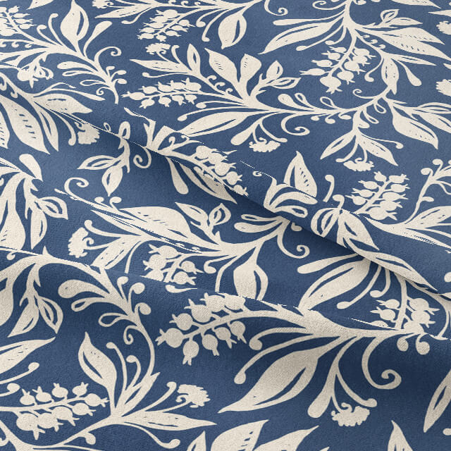 Oxford Leaf Indigo fabric draped to show blue base with ivory leaf print