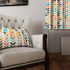 Scandi Stem Orange fabric used for curtains and cushions in a modern living room with neutral armchair
