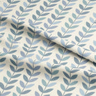 Draped view of Scandi Stem Wedgewood blue leaf linen curtain fabric with stylised leaves in duck egg and wedgewood tones on natural background.