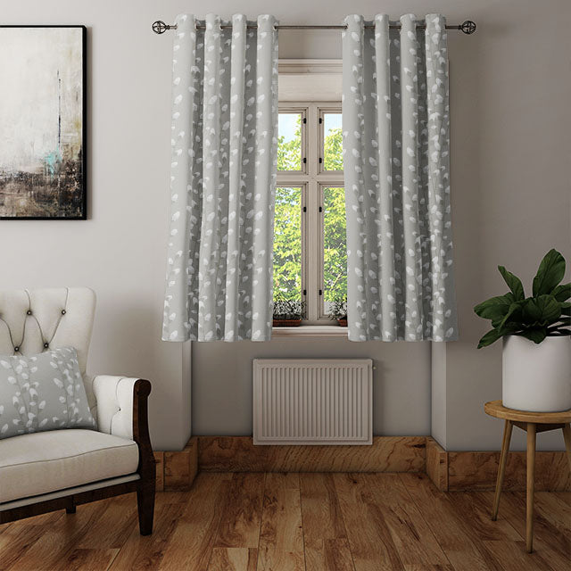 Willow Linen Curtain Fabric in Grey hanging in a stylish living room, adding a modern and chic touch to the decor