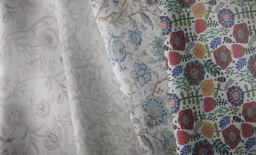 Assorted floral fabrics in various colors and patterns displayed neatly.