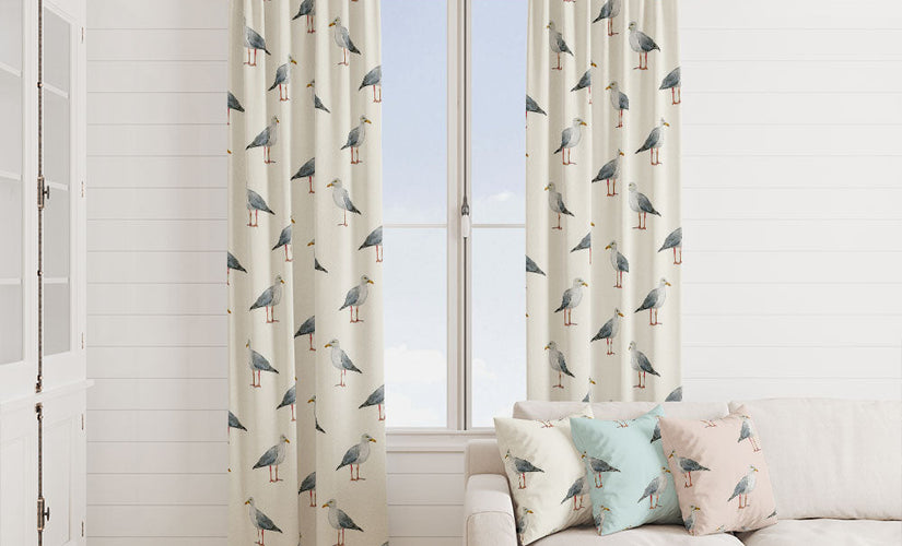 Beach fabric curtains styled in a coastal living room with seaside-inspired cushions