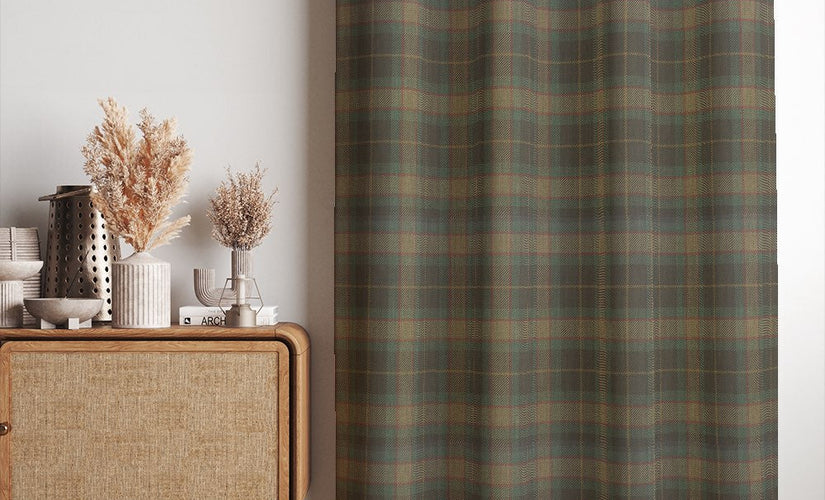 Check made to measure curtain fabric in a muted green tartan design, styled as full-length curtains in a modern living room.