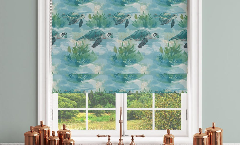 Aqua blind fabric with sea turtle and water lily pattern used on a Roman blind in a modern kitchen