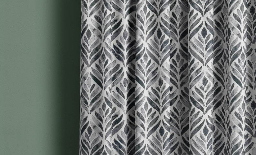 Charcoal made to measure curtains in a bold leaf pattern, tailored to fit for a stylish and contemporary interior look.