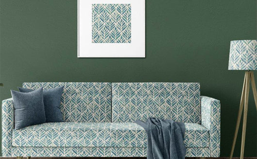 Green and blue patterned upholstery fabric on a modern sofa in a UK living room setting