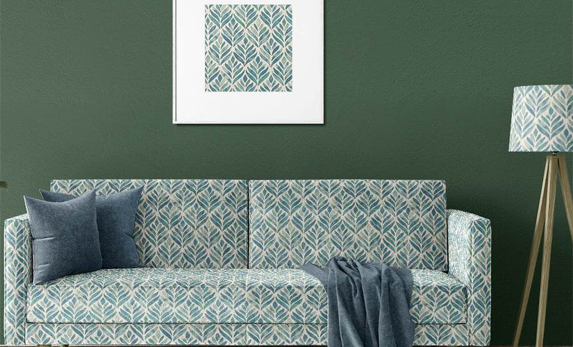 Green and blue patterned upholstery fabric on a modern sofa in a UK living room setting